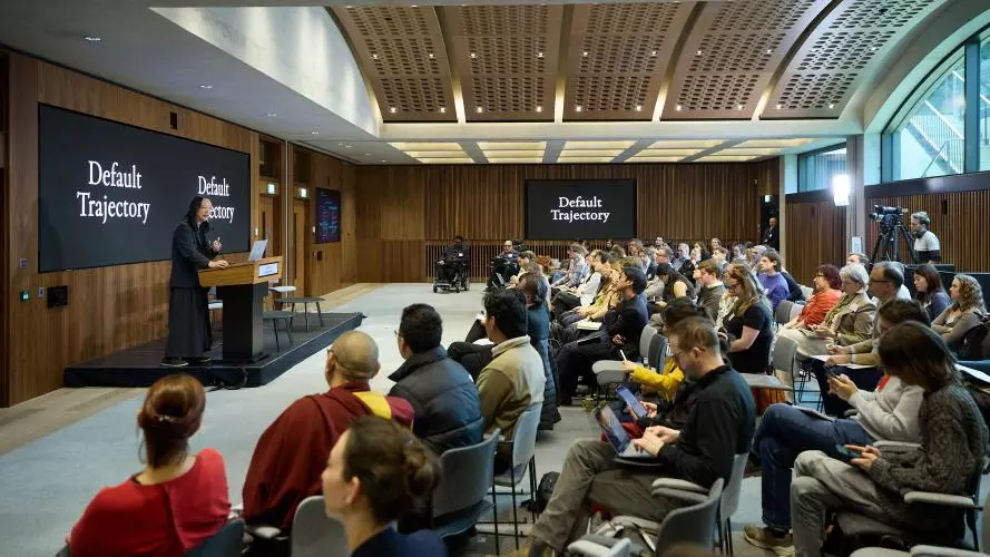 Image shows speaker and audience at the Civic AI summit event
